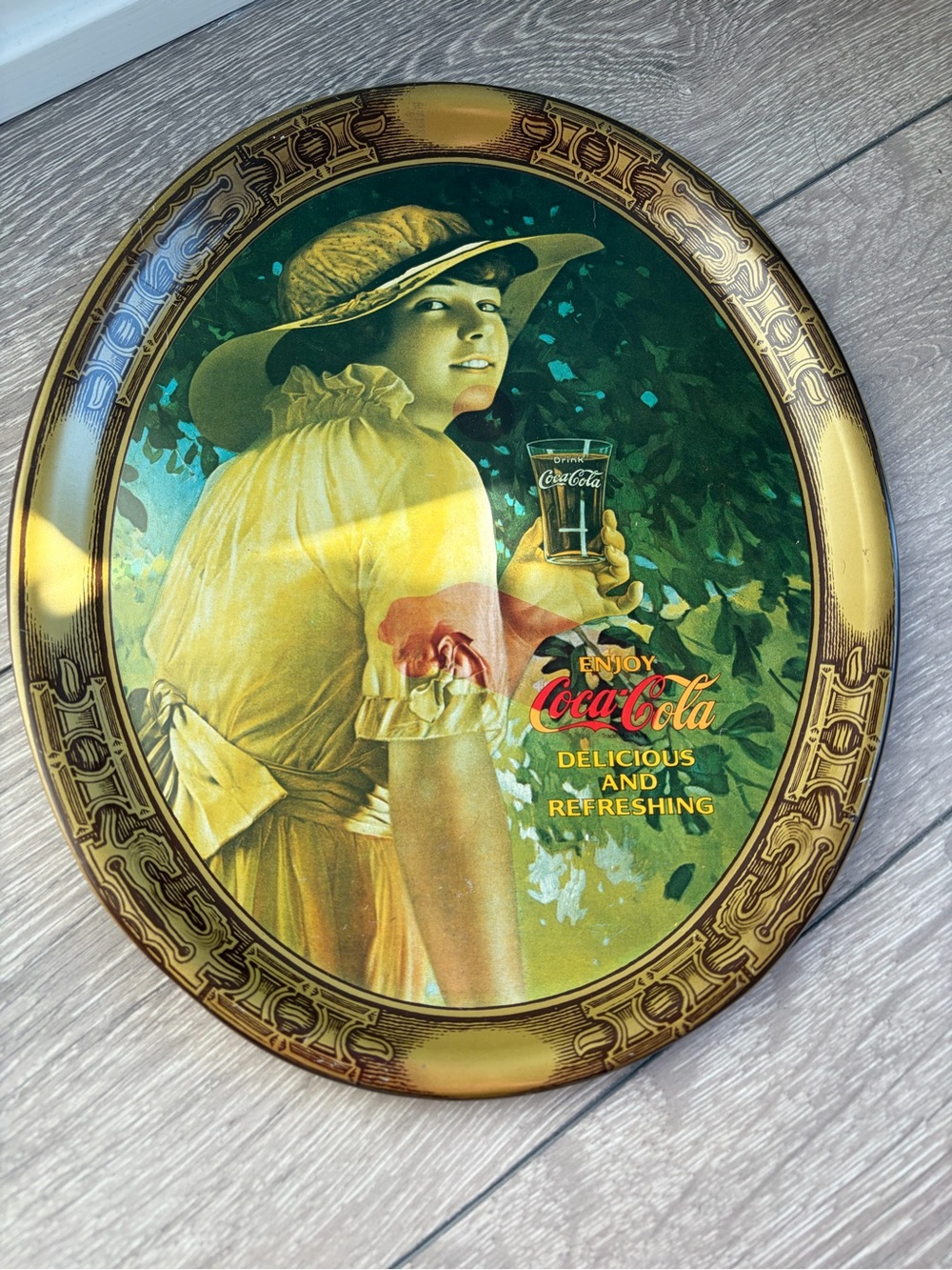 Coca Cola Girl in Yellow Dress with Green Foliage Oval Metal Sign